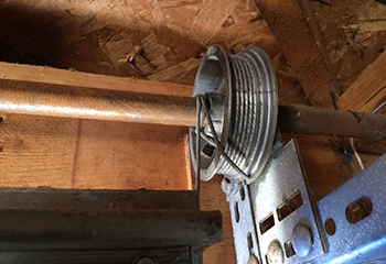 Detailed view of a garage door track and repaired cable inside a Southbury, CT garage