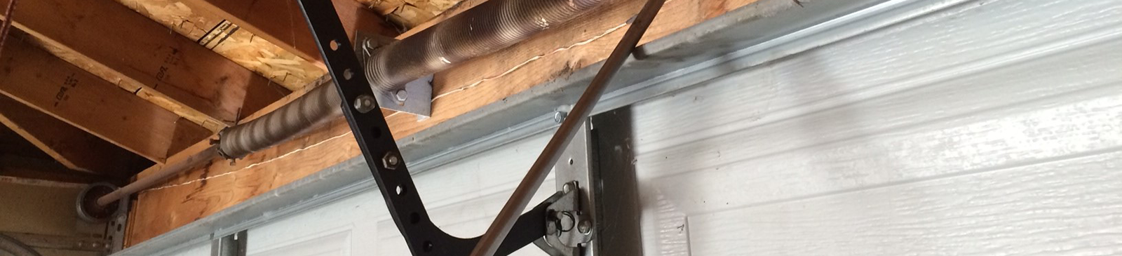 Detailed view of a garage door track and repaired cable inside a Southbury, CT garage